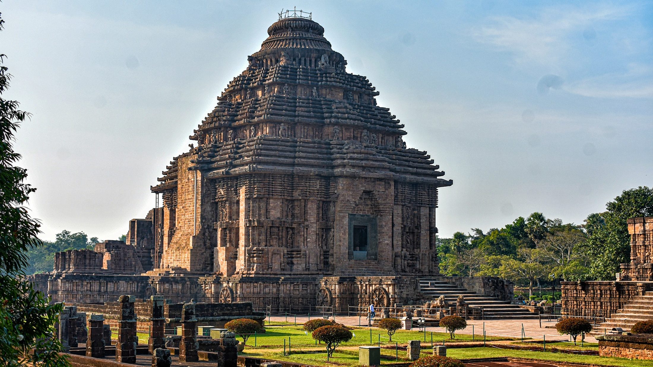 The Sun Temple at Konark, Odisha — carved stone wheels at dusk.